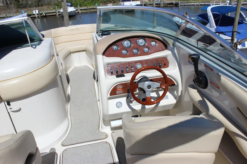 Slide: The Image of 2001 Sea Ray 260 Sundeck boat interior with steering wheel and control panel. - 11