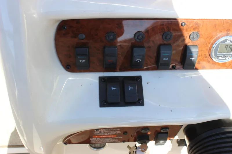 Slide: The Image of Control panel of a 2001 Sea Ray 260 Sundeck boat with switches and gauges. - 13