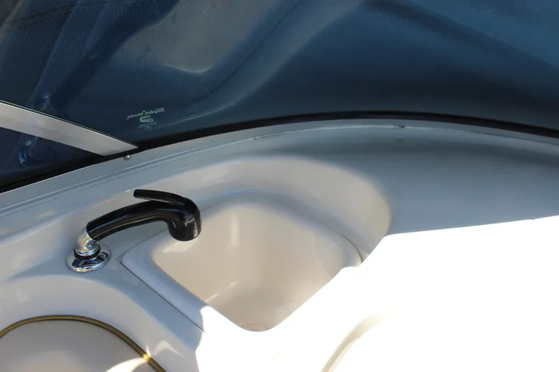 Slide: The Image of 2001 Sea Ray 260 Sundeck interior detail with faucet and seating area. - 17