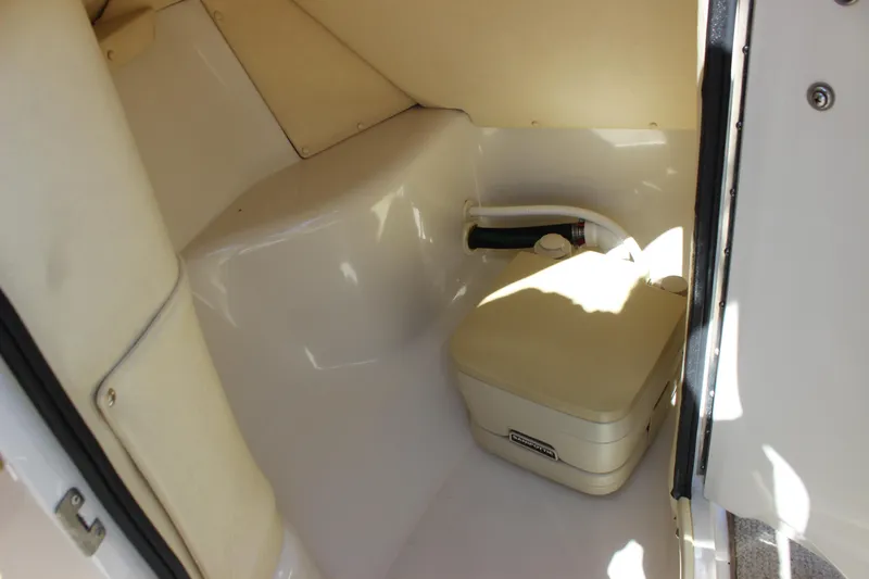 Slide: The Image of 2001 Sea Ray 260 Sundeck interior with compact portable toilet. - 19