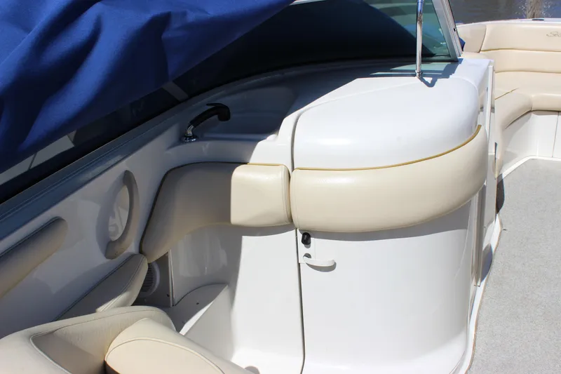 Slide: The Image of 2001 Sea Ray 260 Sundeck interior with beige seating and blue cover. - 21