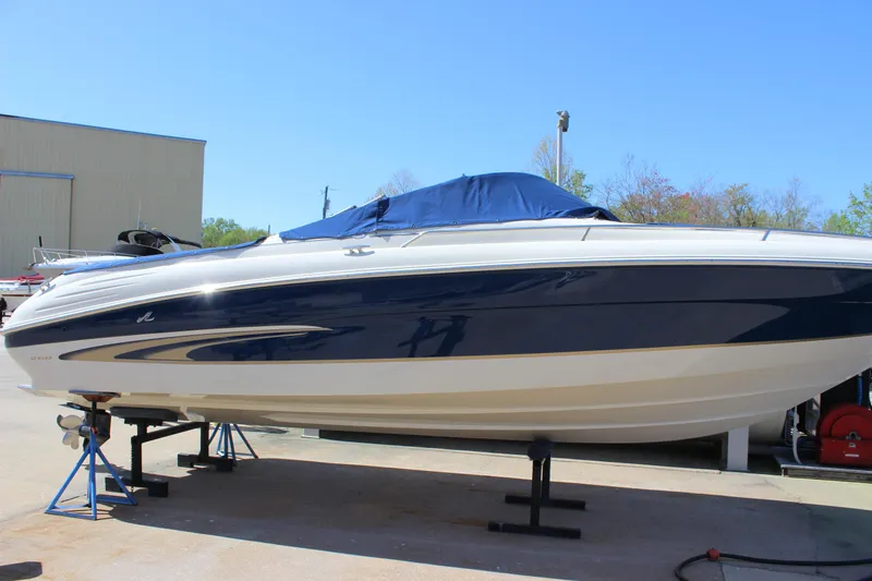 Slide: The Image of 2001 Sea Ray 260 Sundeck boat on display, blue and white exterior. - 4