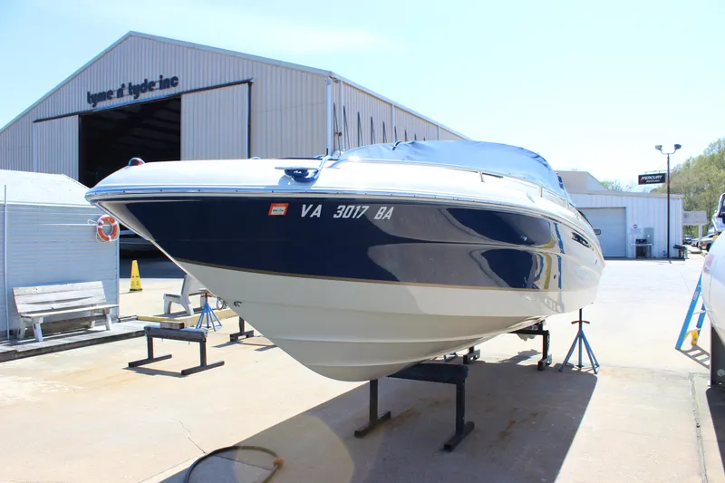 Slide: The Image of 2001 Sea Ray 260 Sundeck boat on stands outside a storage facility. - 5
