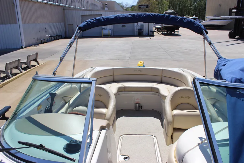 Slide: The Image of 2001 Sea Ray 260 Sundeck boat with open bow seating and blue canopy. - 6