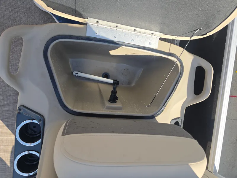 Slide: The Image of 2021 Sun Tracker Bass Buggy 16 DLX boat interior with storage compartment and cup holders. - 8