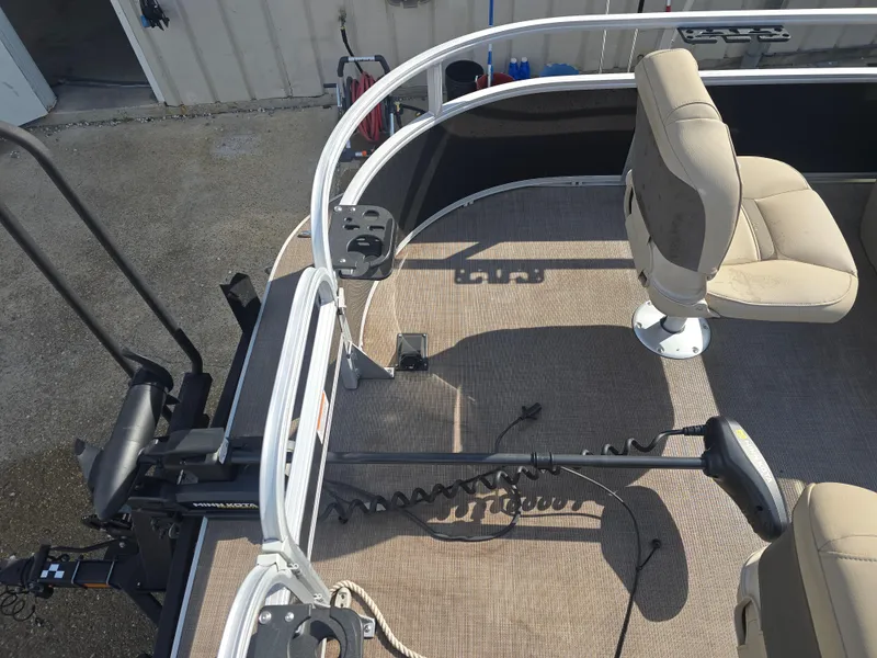 Slide: The Image of 2021 Sun Tracker Bass Buggy 16 DLX pontoon boat interior with seating and motor. - 9