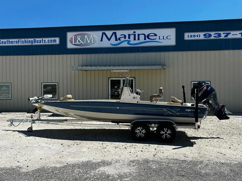 Slide: The Image of 2025 Xpress H22B boat on trailer outside I&M Marine LLC building. - 0