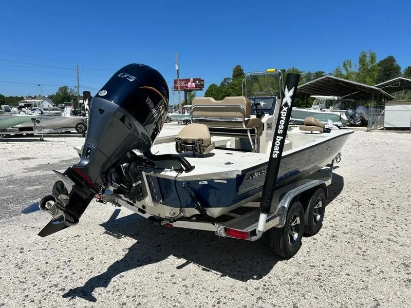 Slide: The Image of 2025 Xpress H22B boat with Yamaha outboard motor on trailer in sunny outdoor setting. - 4