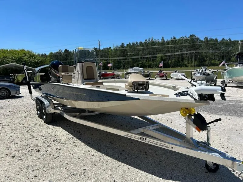 Slide: The Image of 2025 Xpress H22B boat on trailer, parked outdoors, clear sky background. - 5