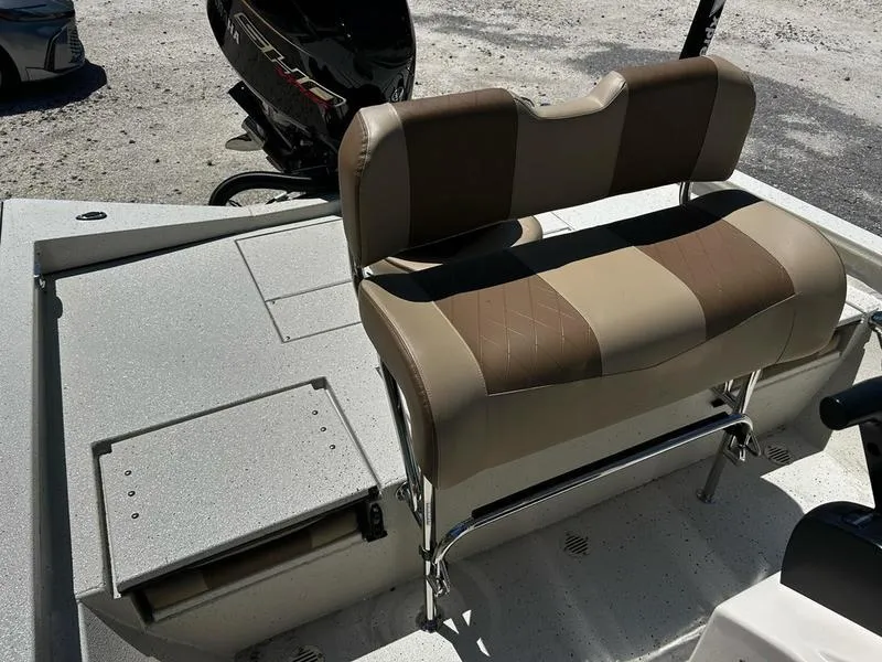 Slide: The Image of 2025 Xpress H22B boat interior with cushioned seating and storage compartment. - 9