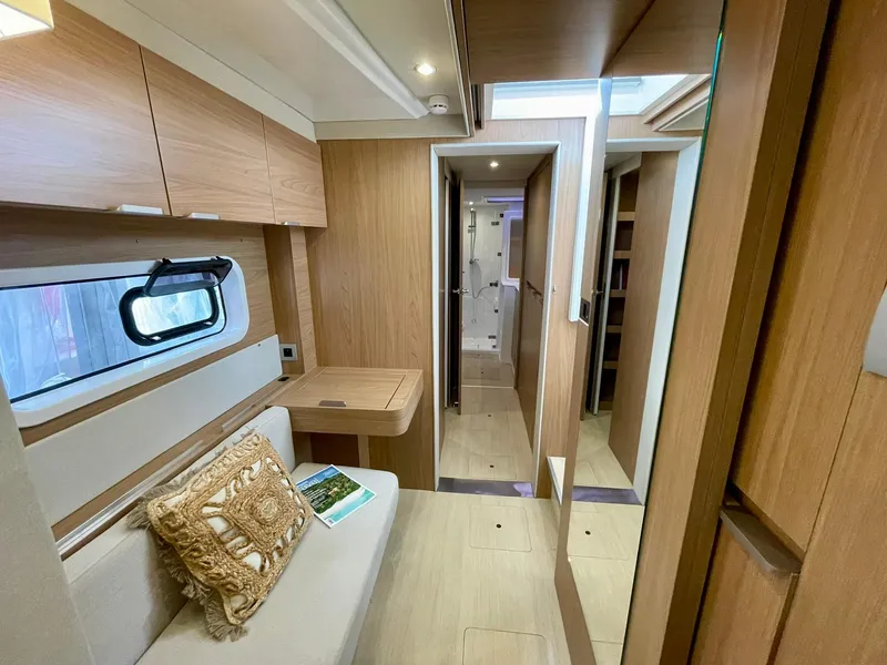 Slide: The Image of Interior of 2026 Bali CATSPACE yacht, featuring modern wood finishes and cozy seating area. - 17