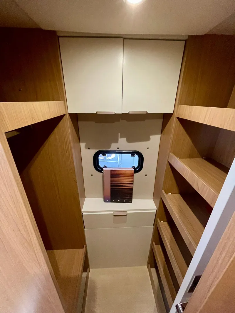 Slide: The Image of 2026 Bali CATSPACE interior with wooden shelves and a small window. - 18