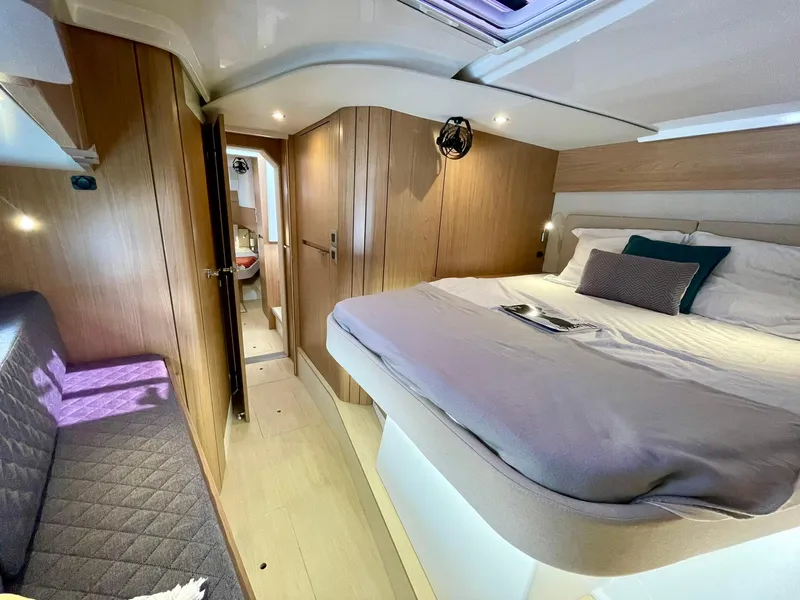 Slide: The Image of Luxurious 2026 Bali CATSPACE yacht interior with cozy bed and modern wood finish. - 27