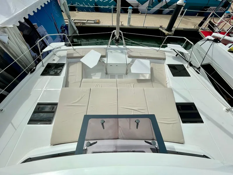 Slide: The Image of 2026 Bali CATSPACE yacht with spacious deck and comfortable seating at a marina. - 33