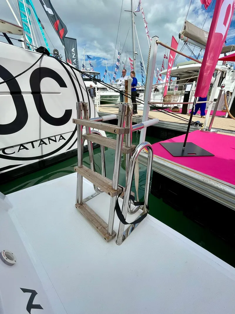 Slide: The Image of Bali CATSPACE 2026 yacht ladder on deck at a boat show, surrounded by colorful flags. - 39