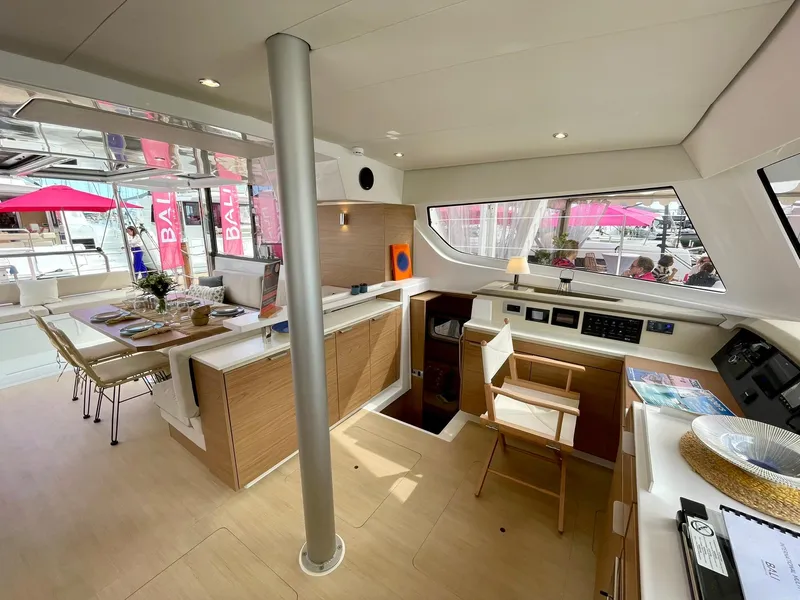 Slide: The Image of Modern interior of 2026 Bali CATSPACE catamaran with dining area and navigation station. - 4