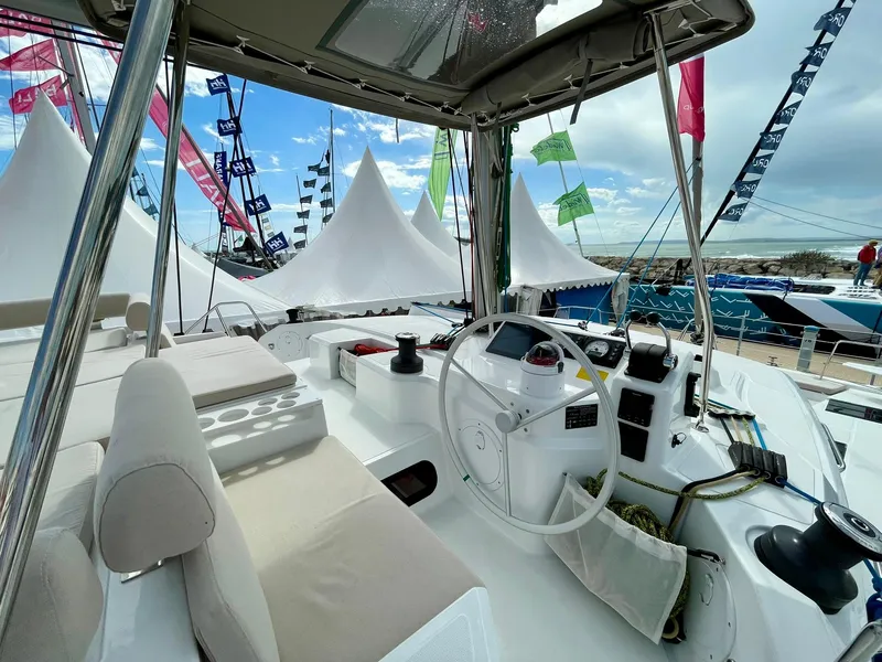 Slide: The Image of Modern 2026 Bali CATSPACE yacht cockpit with steering wheel, comfortable seating, and marina backdrop. - 44