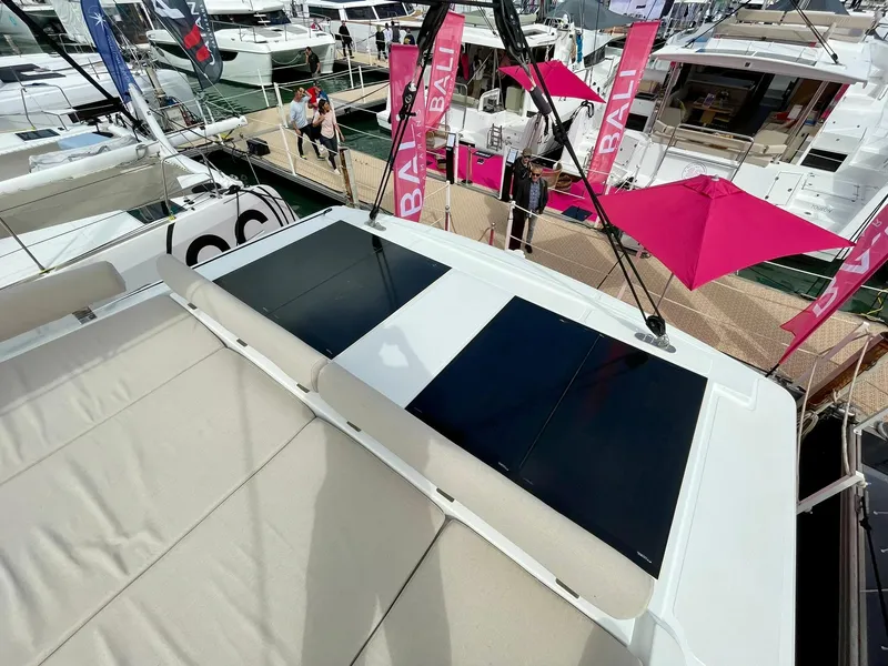 Slide: The Image of 2026 Bali CATSPACE catamaran with solar panels at a boat show, featuring pink Bali banners. - 48