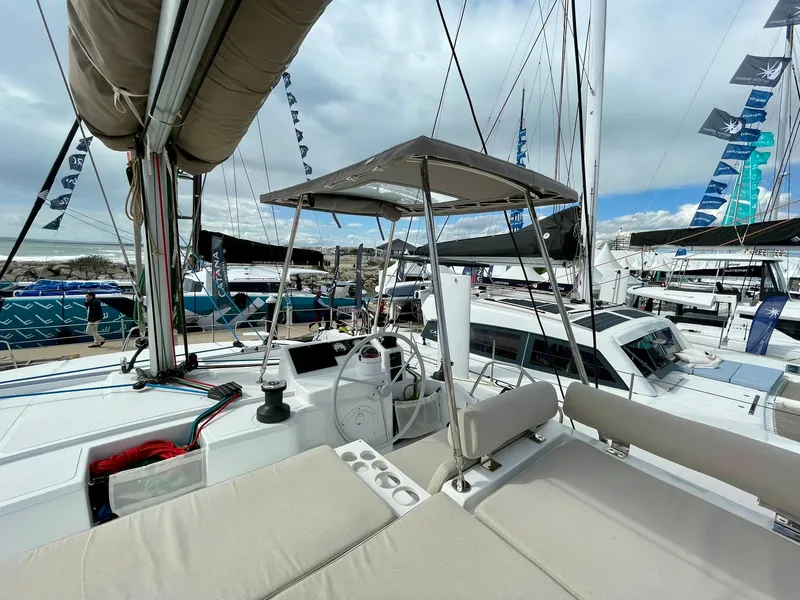 Slide: The Image of Modern Bali CATSPACE 2026 catamaran with spacious deck and helm, docked at marina. - 49