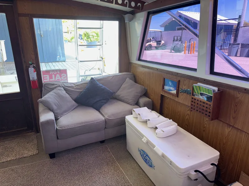 Slide: The Image of Interior of 1981 Bertram 38 Convertible with sofa, cooler, and window view. - 17