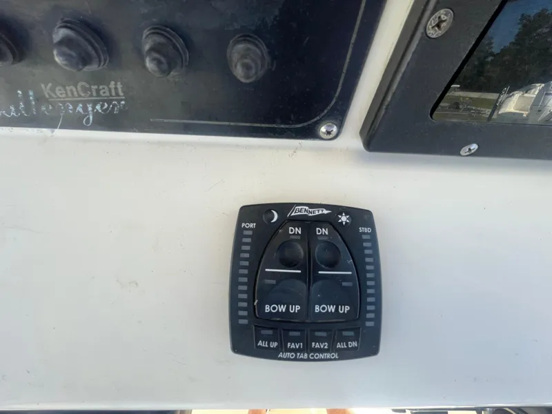 Slide: The Image of Control panel of a 2000 KenCraft Challenger 215 boat with Bennett auto tab controls. - 14