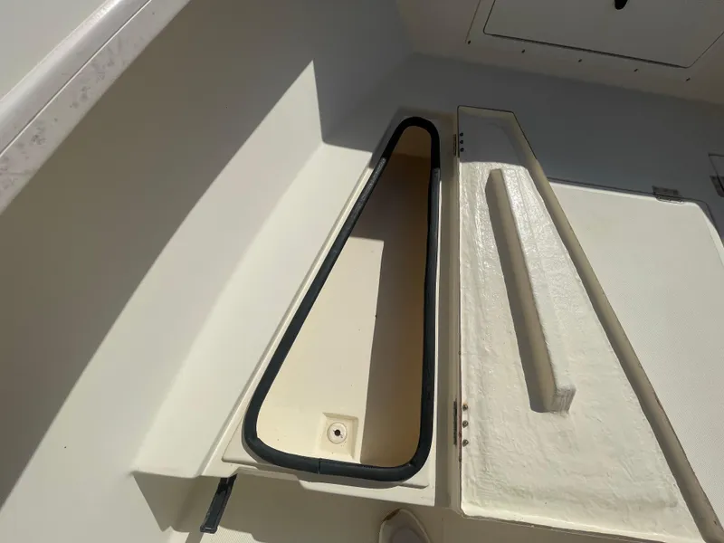 Slide: The Image of Open storage compartment on a 2000 KenCraft Challenger 215 boat. - 16