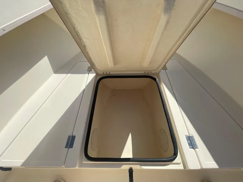 Slide: The Image of Open storage compartment on a 2000 KenCraft Challenger 215 boat. - 17