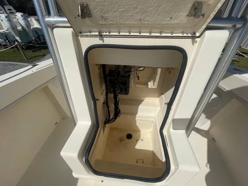 Slide: The Image of Open storage compartment on a 2000 KenCraft Challenger 215 boat, showing interior wiring. - 18