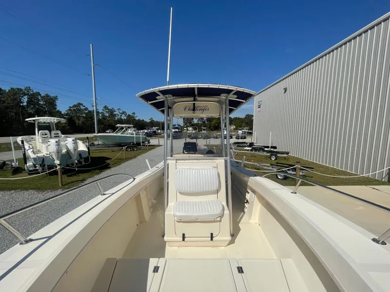 Slide: The Image of 2000 KenCraft Challenger 215 boat with seating, parked outdoors under clear blue sky. - 19