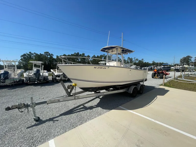Slide: The Image of 2000 KenCraft Challenger 215 boat on trailer in outdoor lot under clear blue sky. - 3