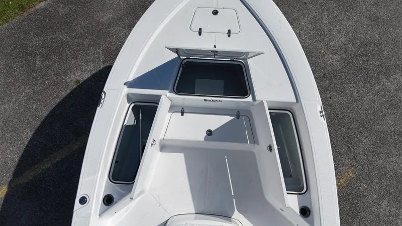 Slide: The Image of 2025 BlackJack 224 boat deck, top view, showcasing storage compartments and sleek design. - 15
