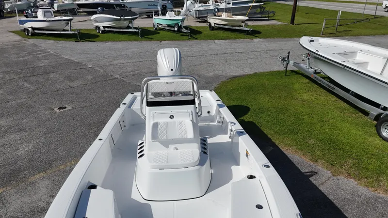 Slide: The Image of 2025 BlackJack 224 boat on display in a marina with other vessels. - 16