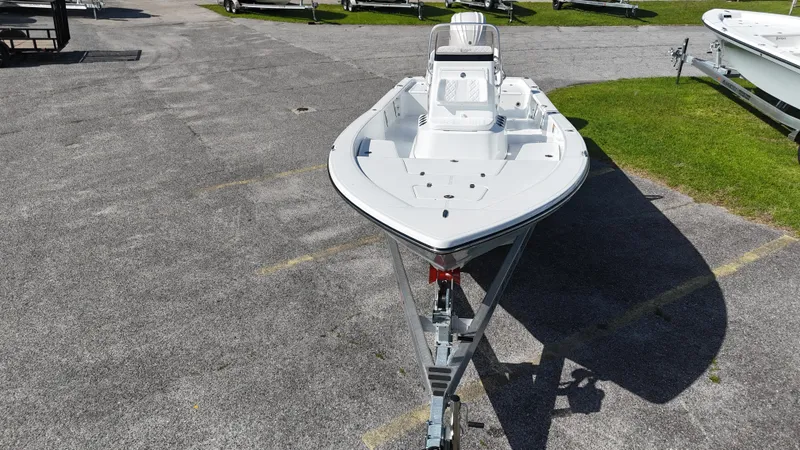 Slide: The Image of 2025 BlackJack 224 boat on trailer, parked on asphalt near grass. - 4