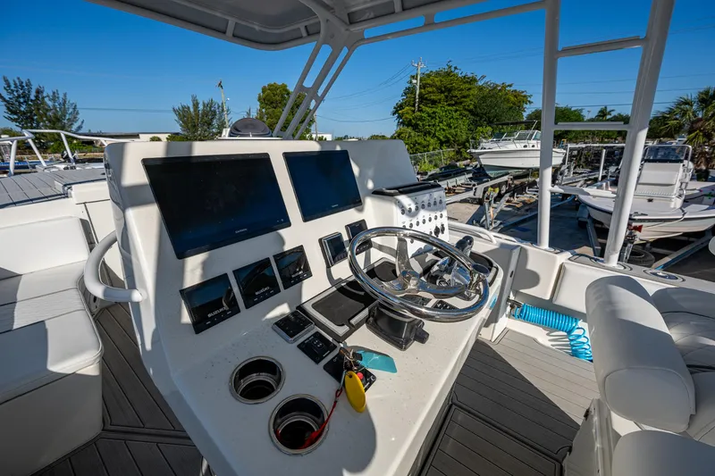 Slide: The Image of Cockpit of 2004 Salt Shaker 300 CC boat with steering wheel and navigation screens. - 10