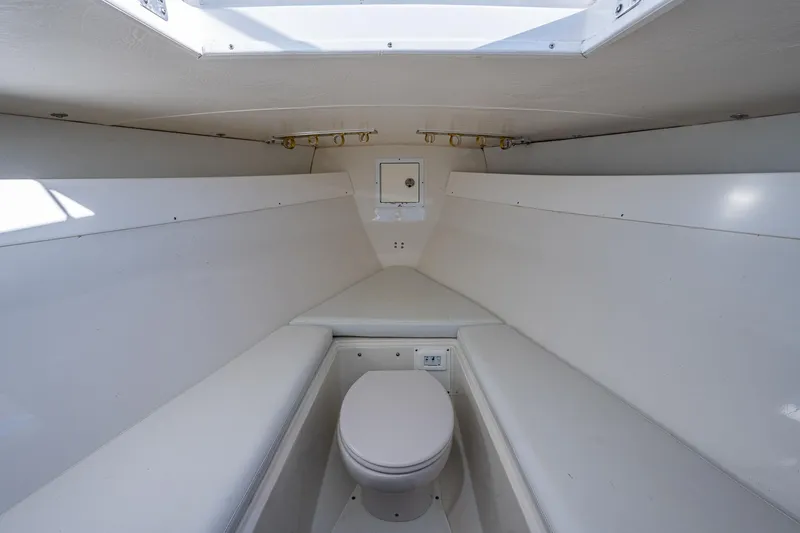 Slide: The Image of Interior of a 2004 Salt Shaker 300 CC boat featuring a compact marine toilet. - 12