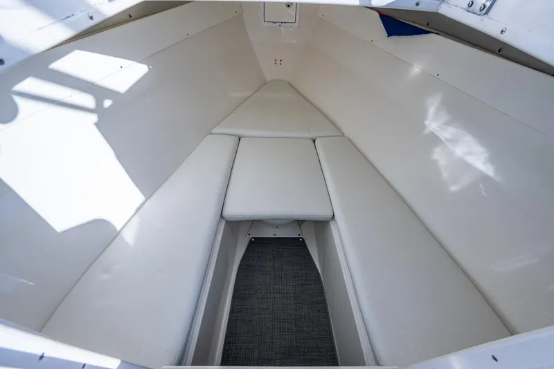 Slide: The Image of Interior view of a 2004 Salt Shaker 300 CC boat cabin with white seating. - 13