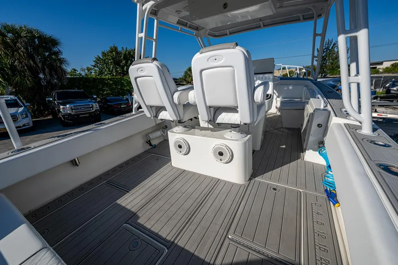Slide: The Image of Open deck of a 2004 Salt Shaker 300 CC boat with seating and storage. - 14