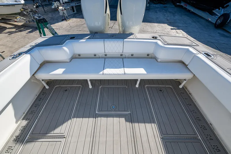 Slide: The Image of 2004 Salt Shaker 300 CC boat interior with white seating and spacious deck. - 17