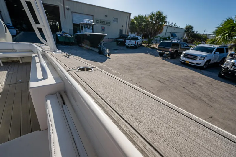Slide: The Image of Outdoor view of a Salt Shaker 300 CC boat near a garage, surrounded by vehicles. - 21