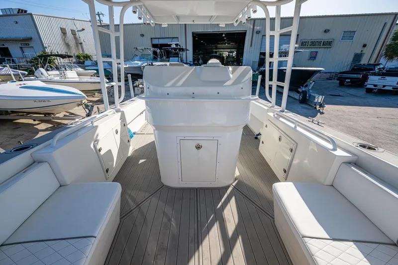 Slide: The Image of 2004 Salt Shaker 300 CC boat interior with seating and storage, docked at a marina. - 6