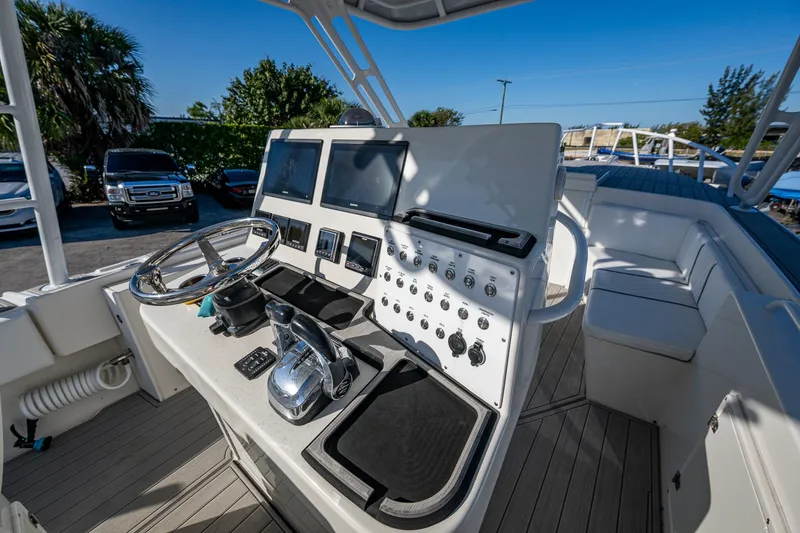 Slide: The Image of ```json
{
"alt_text": "2004 Salt Shaker 300 CC boat dashboard with steering wheel and controls."
}
``` - 9