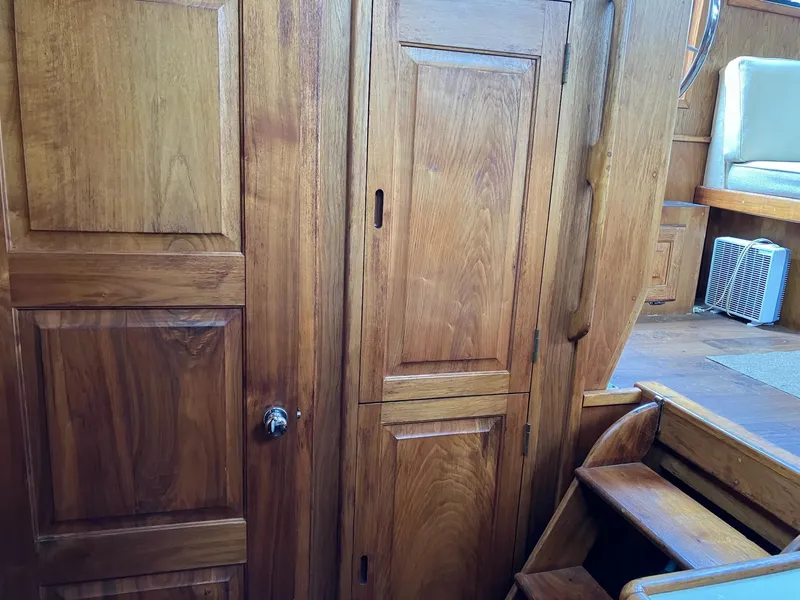 Slide: The Image of 1985 Wellcraft California boat interior with wooden cabinetry and stairs. - 11