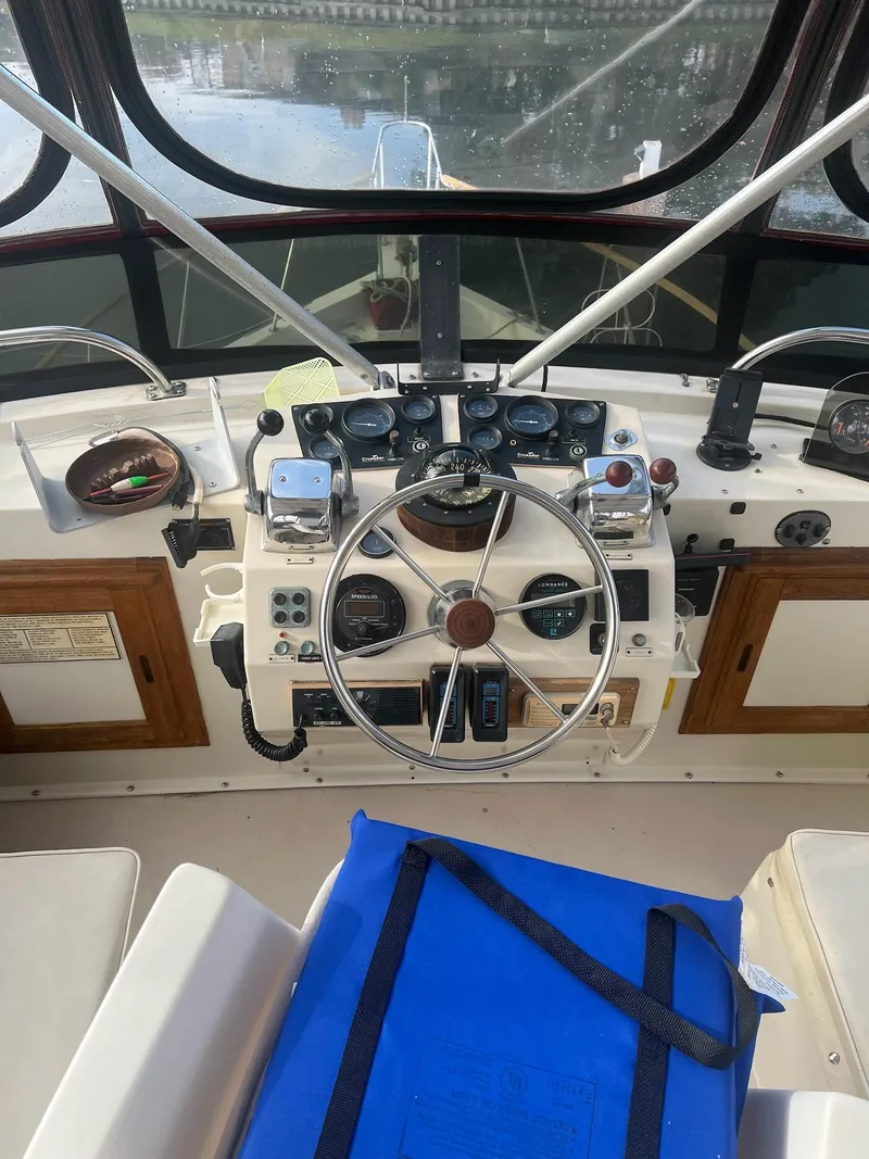 Slide: The Image of 1985 Wellcraft California boat cockpit with steering wheel and control panel. - 6