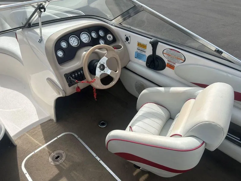 Slide: The Image of 2001 Chaparral 200 SSe boat interior with steering wheel and dashboard controls. - 2