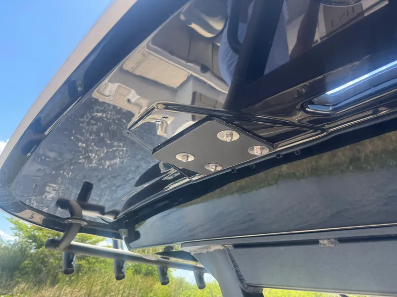 Slide: The Image of 2023 Yamaha Boats 255 FSH Sport E, close-up of sleek black hull detail. - 14