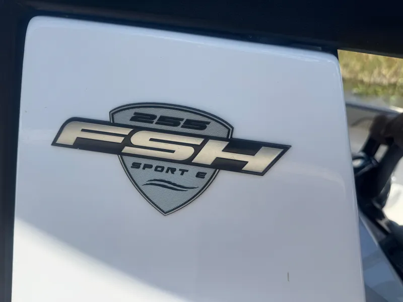 Slide: The Image of 2023 Yamaha Boats 255 FSH Sport E logo on white surface. - 19