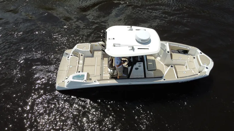 Slide: The Image of 2023 Yamaha Boats 255 FSH Sport E on water, aerial view. - 2