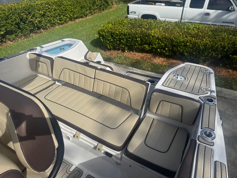 Slide: The Image of 2023 Yamaha Boats 255 FSH Sport E interior with beige seating and sleek design. - 24