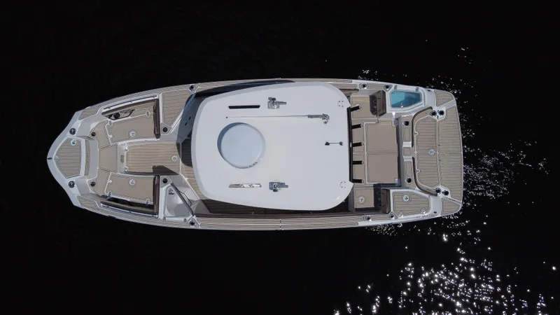 Slide: The Image of 2023 Yamaha Boats 255 FSH Sport E, aerial view, sleek design on dark water. - 4