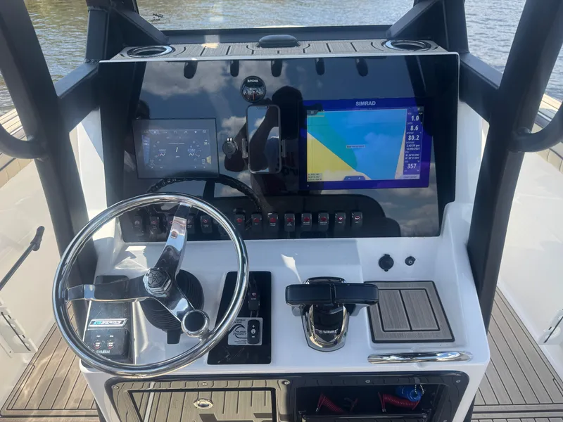 Slide: The Image of 2023 Yamaha Boats 255 FSH Sport E dashboard with navigation screens and controls. - 9